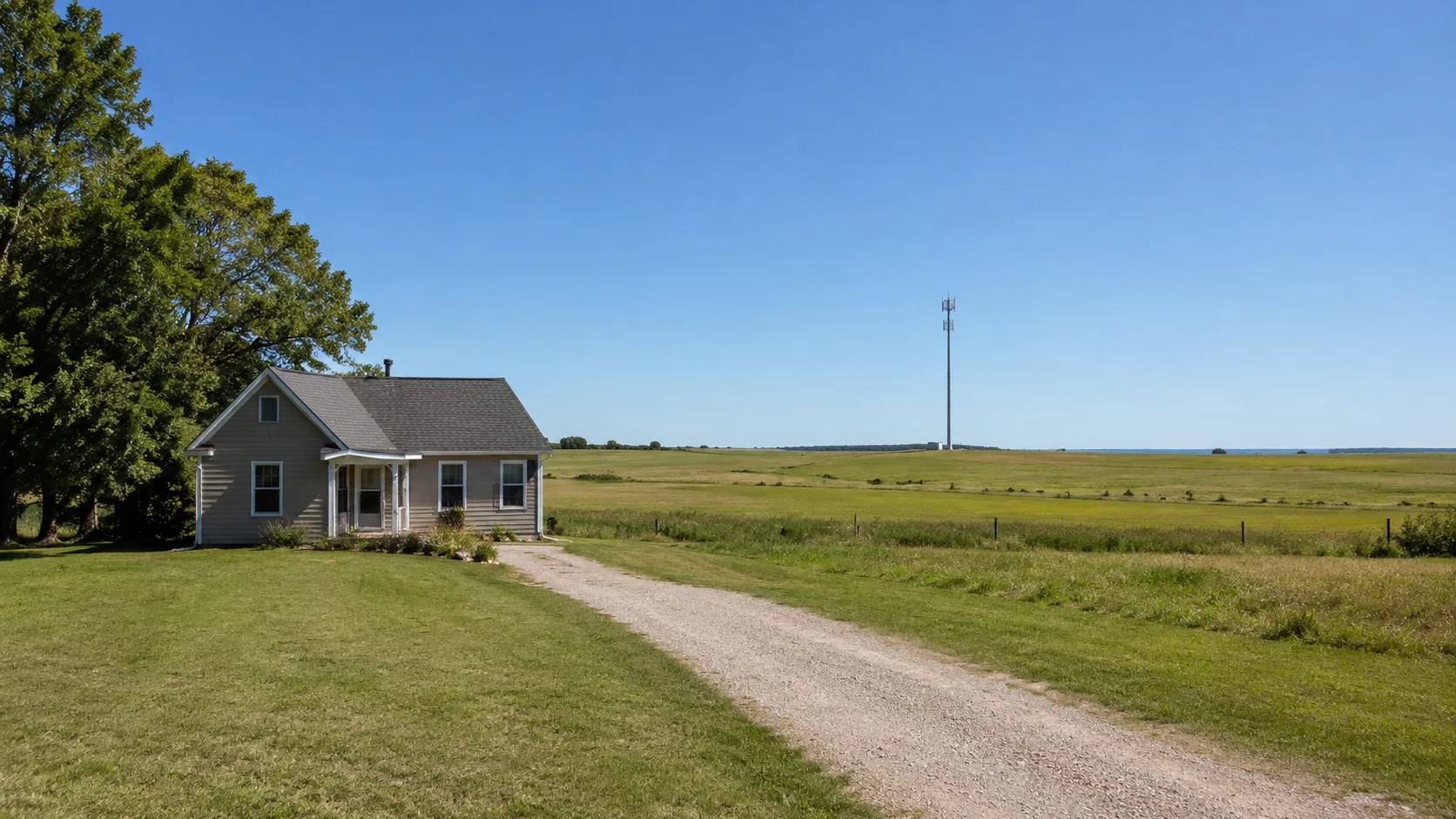 A rural home with a clear connection to a distant cell tower across open country
